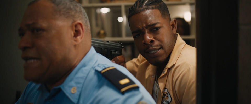 This image released by Quibi shows Laurence Fishburne, left, and Stephan James in a scene from "#FreeRayShawn." This engrossing crime drama centers on fast food worker who we meet zooming through the back streets of New Orleans with what seems like every city officer on his tail. He's been set up by police on a drug deal and takes refuge inside his apartment building with his girlfriend and child. (Quibi via AP)