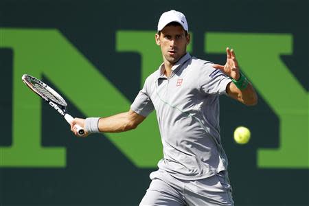 Mar 26, 2014; Miami, FL, USA; Novak Djokovic hits a forehand against Andy Murray (not pictured) on day ten of the Sony Open at Crandon Tennis Center. Geoff Burke-USA TODAY Sports