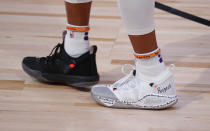 The shoes of Phoenix Suns' Jevon Carter are seen during the first half of an NBA basketball game against the Indiana Pacers' Thursday, Aug. 6, 2020, in Lake Buena Vista, Fla. (Kevin C. Cox/Pool Photo via AP)