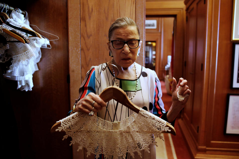 U.S. Supreme Court Justice Ruth Bader Ginsburg, in her chambers, shows the many collars (jabots) she wears with her robes.