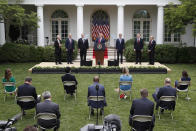President Donald Trump speaks in the Rose Garden of the White House, Friday, May 29, 2020, in Washington. From left with Trump are, White House trade adviser Peter Navarro, White House national security adviser Robert O'Brien, Secretary of State Mike Pompeo, Treasury Secretary Steven Mnuchin, U.S. Trade Representative Robert Lighthizer and White House chief economic adviser Larry Kudlow. (AP Photo/Alex Brandon)