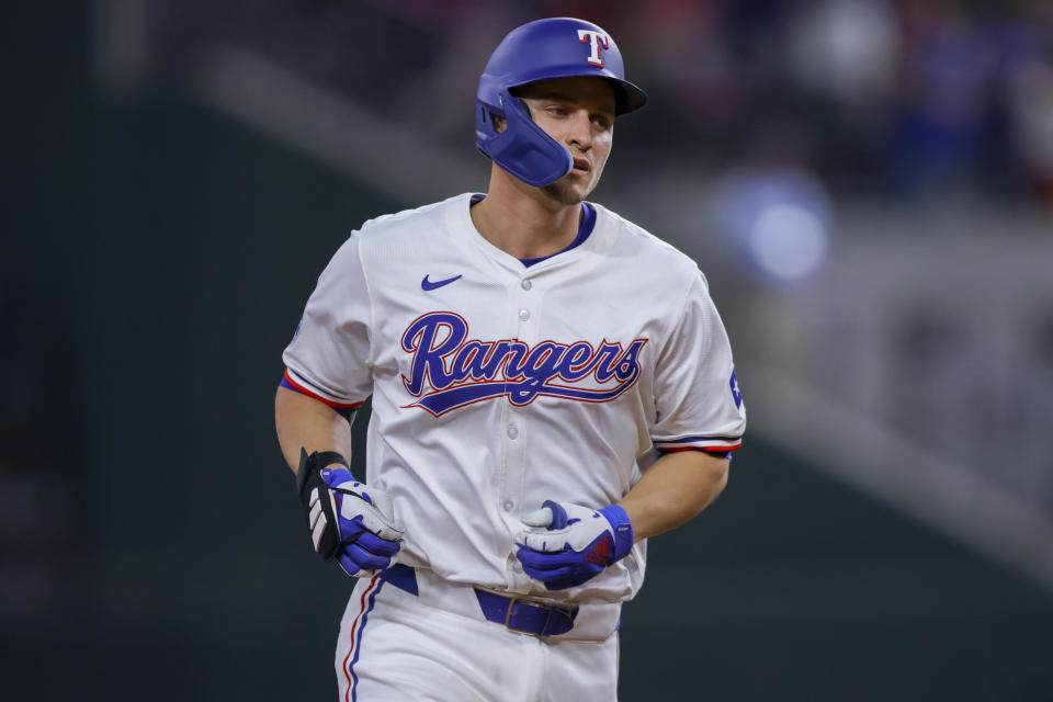 Texas Rangers' Corey Seager jogs around second base after hitting a home run during the ninth inning of a baseball game against the Cincinnati Reds in Arlington, Texas, Saturday, April 27, 2024. (AP Photo/Gareth Patterson)