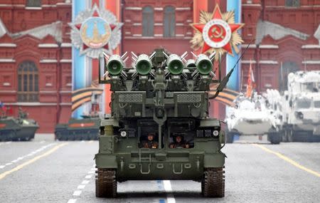 Two Russian servicemen sit inside a Buk-M2 missile system during the 72nd anniversary of the end of World War II on the Red Square in Moscow. REUTERS/Maxim Shemetov