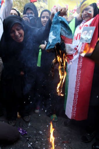 Iranian demonstrators burn a US flag outside the former US embassy in Tehran. Thousands of Iranians chanting "Death to America" burnt US flags to mark the 33rd anniversary of the seizure of the US embassy in Tehran