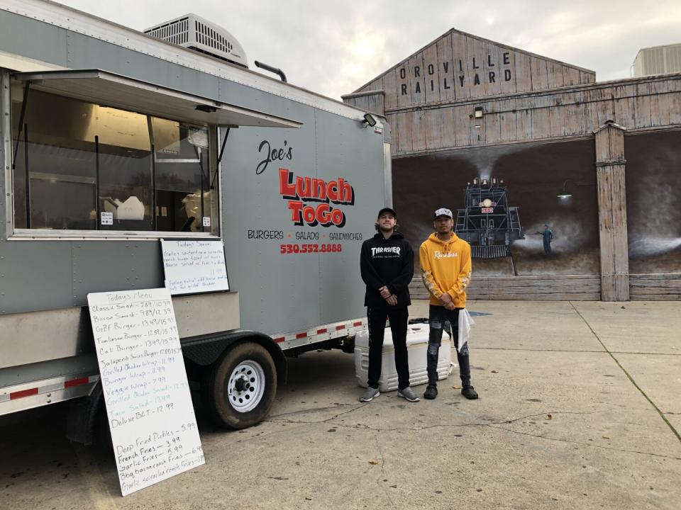 Joseph Tomlinson, left, and his cousin, Robert Steele, outside Joe's Lunch ToGo food truck in downtown Oroville.