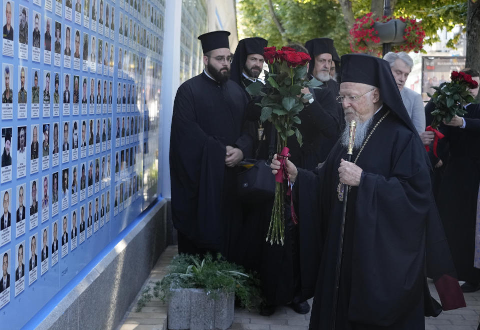 Ecumenical Patriarch Bartholomew I, lays flowers at the Memorial Wall of Fallen Defenders of Ukraine in Russian-Ukrainian War in Kyiv, Ukraine, Saturday, Aug. 21, 2021. Bartholomew I, arrived to Kyiv to mark the 30th anniversary of Ukraine's independence that is celebrated on Aug. 24. (AP Photo/Efrem Lukatsky)