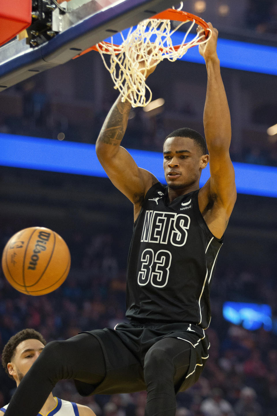 Brooklyn Nets center Nic Claxton dunks over Golden State Warriors guard Klay Thompson (11) during the first quarter of an NBA basketball game, Sunday, Jan. 22, 2023, in San Francisco. (AP Photo/D. Ross Cameron)