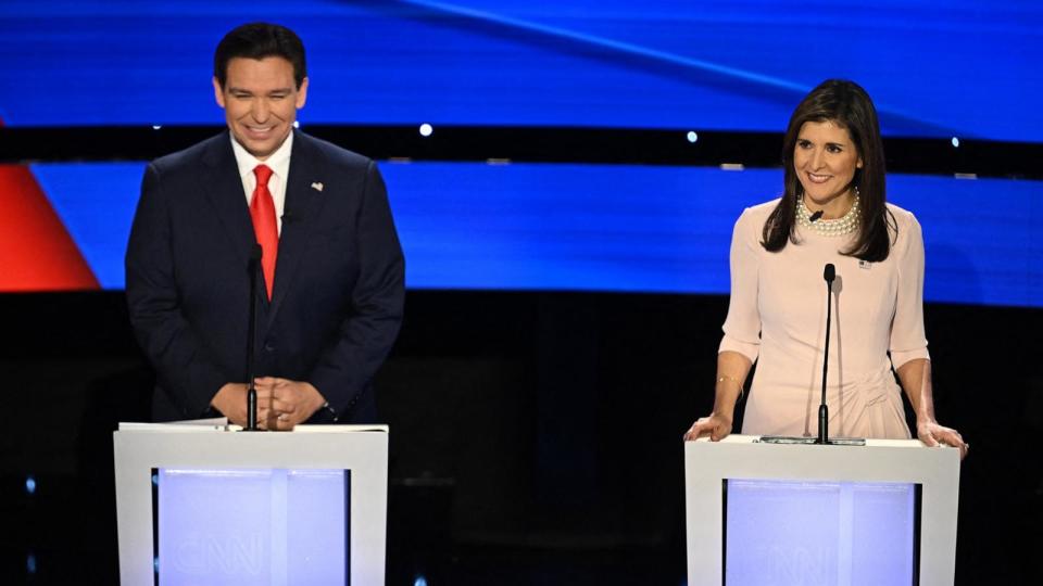PHOTO: Florida Governor Ron DeSantis (L) and former US Ambassador to the UN Nikki Haley smile during the fifth Republican presidential primary debate at Drake University in Des Moines, Iowa, on Jan. 10, 2024.  (Jim Watson/AFP via Getty Images, FILE)
