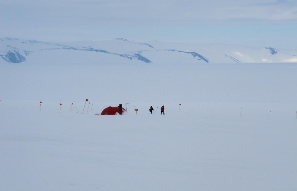 In this Sunday, Jan. 20, 2013 photo, cross-country skiers pass a survival shelter on Hut Point Peninsula of Ross Island, Antarctica. Tourism is rebounding here five years after the financial crisis stifled what had been a burgeoning industry. And it’s not just retirees watching penguins from the deck of a ship. Visitors are taking tours inland and even engaging in “adventure tourism” like skydiving and scuba diving under the ever-sunlit skies of a Southern Hemisphere summer. (AP Photo/Rod McGuirk)