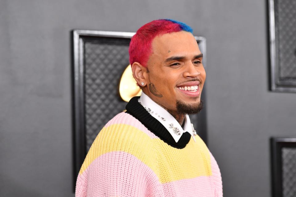 American singer Chris Brown wearing a pink and yellow sweater at Grammys.