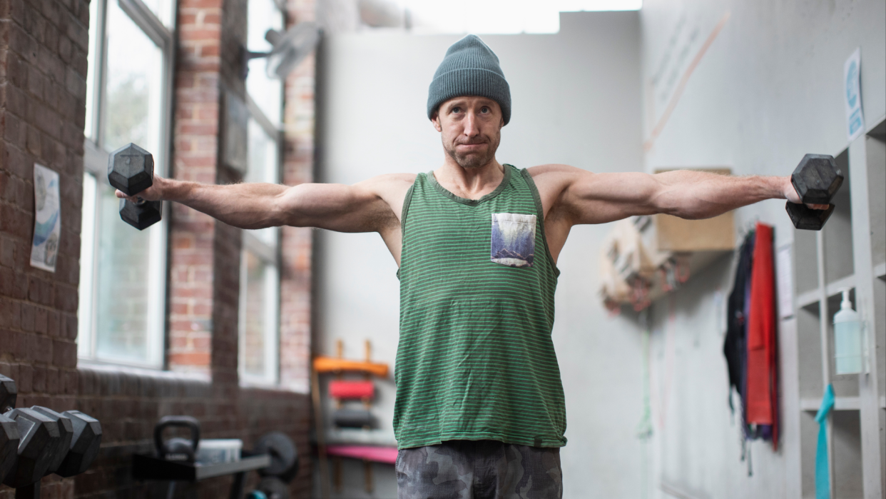  Man performing Poliquin raises in his home. 