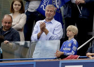 FILE - Chelsea's owner Roman Abramovich, center, applauds after Chelsea were presented with the Premier League trophy after their English Premier League soccer match against Sunderland at Stamford Bridge stadium in London, May 24, 2015. Chelsea owner Roman Abramovich has on Saturday, Feb. 26, 2022 suddenly handed over the “stewardship and care” of the Premier League club to its charitable foundation trustees. The move came after a member of the British parliament called for the Russian billionaire to hand over the club in the wake of Russia’s invasion of Ukraine. (AP Photo/Matt Dunham, file)