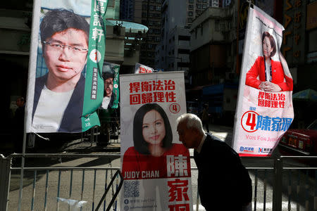 Banners of pro-democracy candidate Au Nok-hin and pro-government candidate Judy Chan are displayed on a street during a Legislative Council by-election in Hong Kong, China March 11, 2018. REUTERS/Bobby Yip