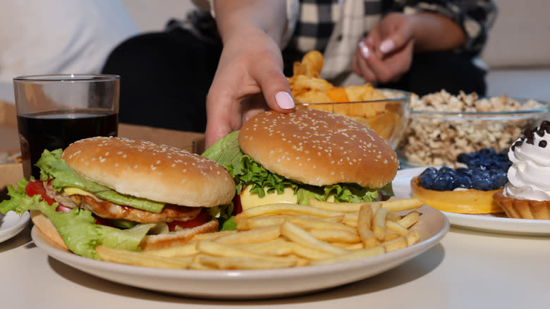 Hand reaching for burgers