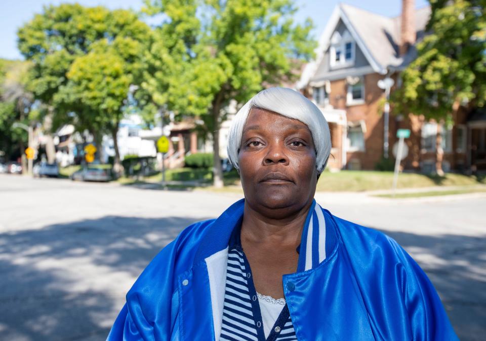 Sharyl MacFarland stands near her home in Milwaukee. From her front porch, she can count down her block house after house where someone has been sent to prison. She includes her own house. All three of her sons have spent time behind bars; two of her brothers have been in prison for most of their lives.