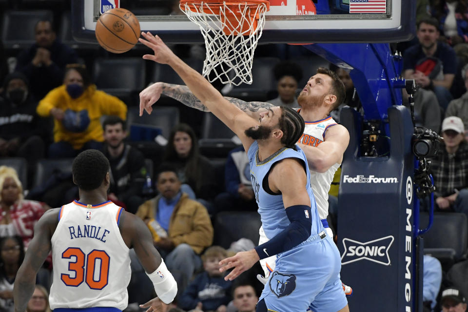 New York Knicks center Isaiah Hartenstein, right, blocks a shot by Memphis Grizzlies forward David Roddy (21) during the first half of an NBA basketball game Saturday, Jan. 13, 2024, in Memphis, Tenn. (AP Photo/Brandon Dill)