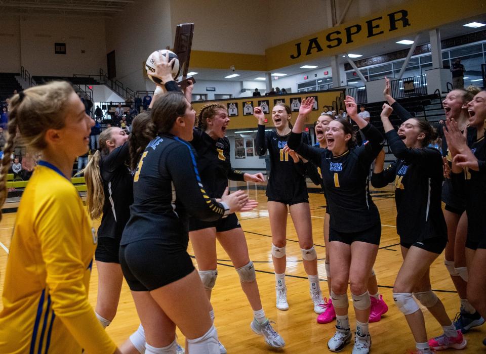 The Castle Knights celebrate their victory over the North Huskies during the IHSAA Class 4A Volleyball Sectional championship in Jasper, Ind., Saturday, Oct. 14, 2023.