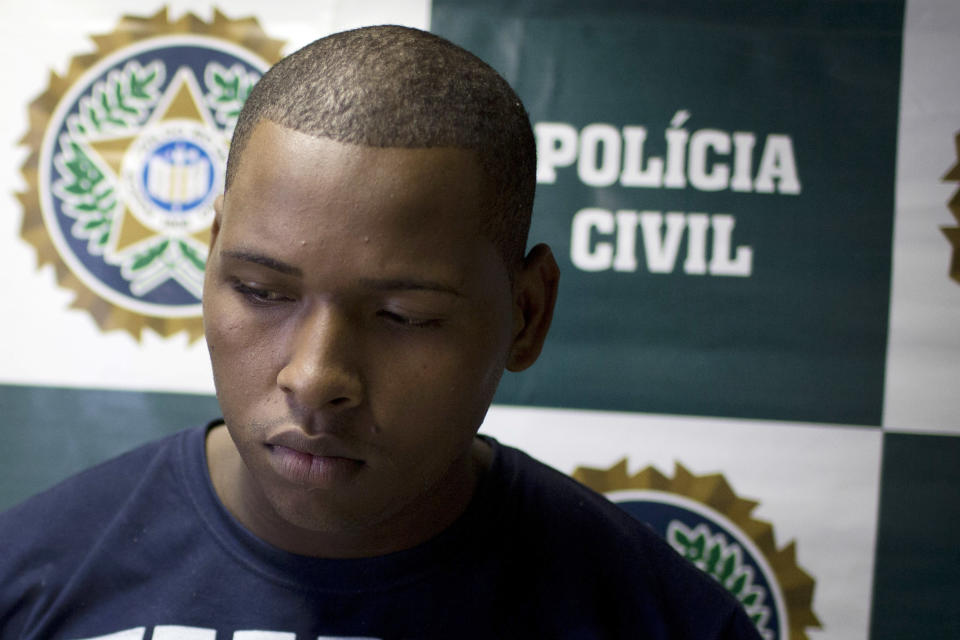 Wallace Aparecido Souza Silva is presented to the press at Special Police Unit for Tourism Support (DEAT) after being arrested for allegedly attacking tourists in Rio de Janeiro, Brazil, Tuesday, April 2, 2013. An American woman was gang raped and beaten aboard a public transport van while her French boyfriend was shackled, hit with a crowbar and forced to watch the attacks after the pair boarded the vehicle in Rio de Janeiro's showcase Copacabana beach neighborhood, police said. The attacks took place over six hours starting shortly after midnight on Saturday. (AP Photo/Felipe Dana)