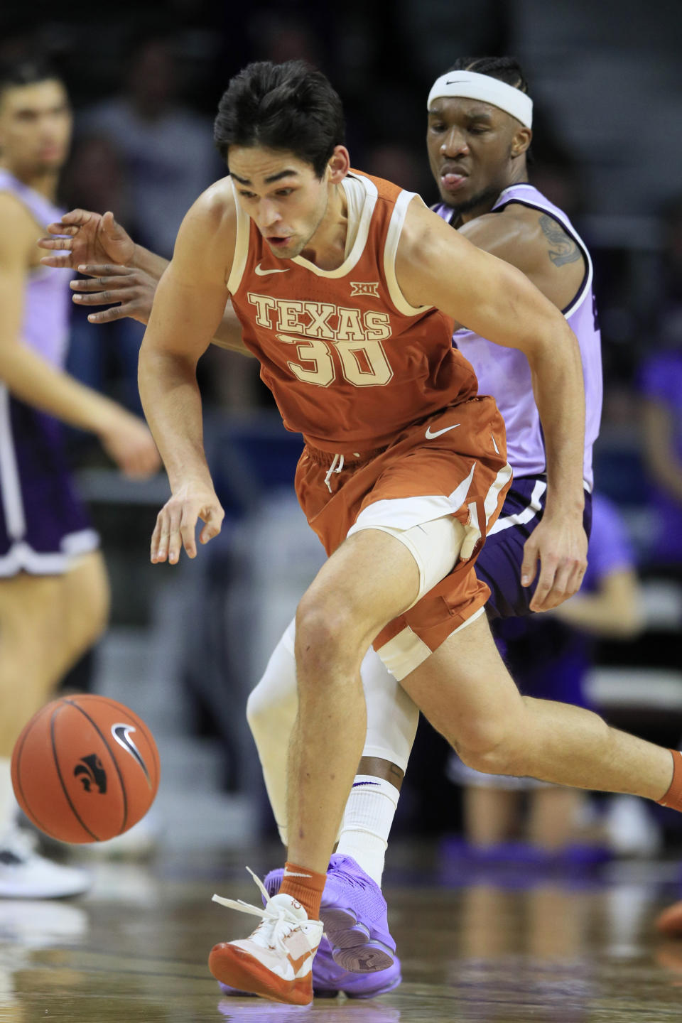 Texas forward Brock Cunningham (30) steals the ball in front of Kansas State forward Xavier Sneed, back, during the first half of an NCAA college basketball game in Manhattan, Kan., Saturday, Feb. 22, 2020. (AP Photo/Orlin Wagner)