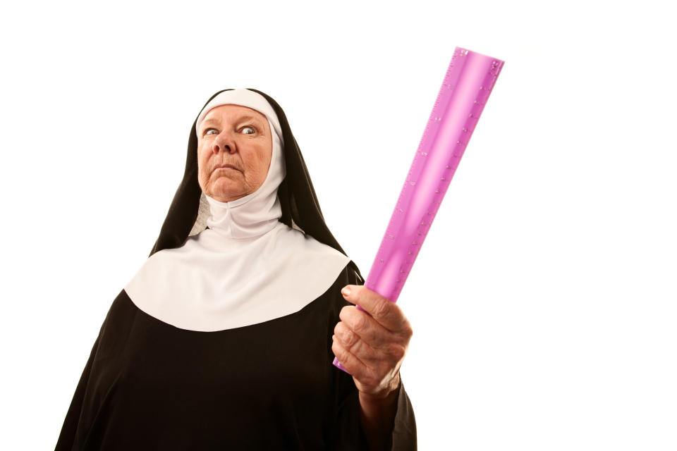 nun threatening with a ruler