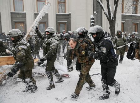Riot police detain anti-government protesters, as service members of the National Guard remove a protest tent camp, near the parliament building in Kiev, Ukraine March 3, 2018. REUTERS/Gleb Garanich