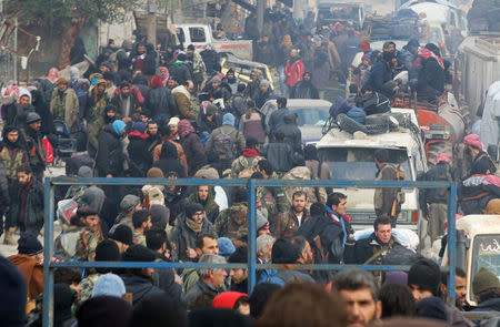 Rebel fighters and civilians gather as they wait to be evacuated from a rebel-held sector of eastern Aleppo, Syria December 16, 2016. REUTERS/Abdalrhman Ismail