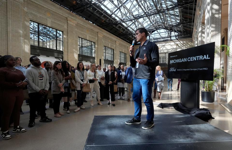 Marin Gjaja, the Chief Operating Officer for the Ford Model e team, talks with his employees inside Michigan Central Station on their first day of work at the renovated train station, Tuesday, Oct. 8, 2024.