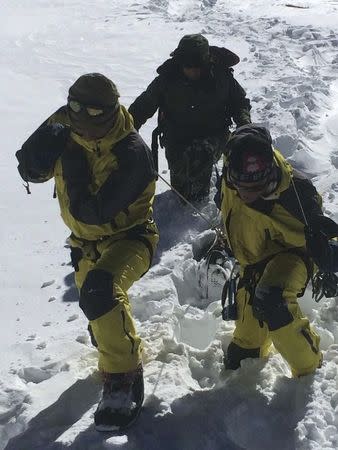 Nepalese army personnel drag the bodies of victims recovered after an avalanche at Thorang-La in Annapurna Region in this October 16, 2014 handout photo provided by Nepal Army. REUTERS/Nepal Army/Handout via Reuters