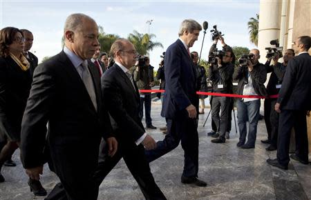 U.S. Secretary of State John Kerry is escorted by staff members as he arrives at the Foreign Ministry in Rabat, April 4, 2014, where he will attend a bilateral strategic dialogue. REUTERS/Jacquelyn Martin/Pool