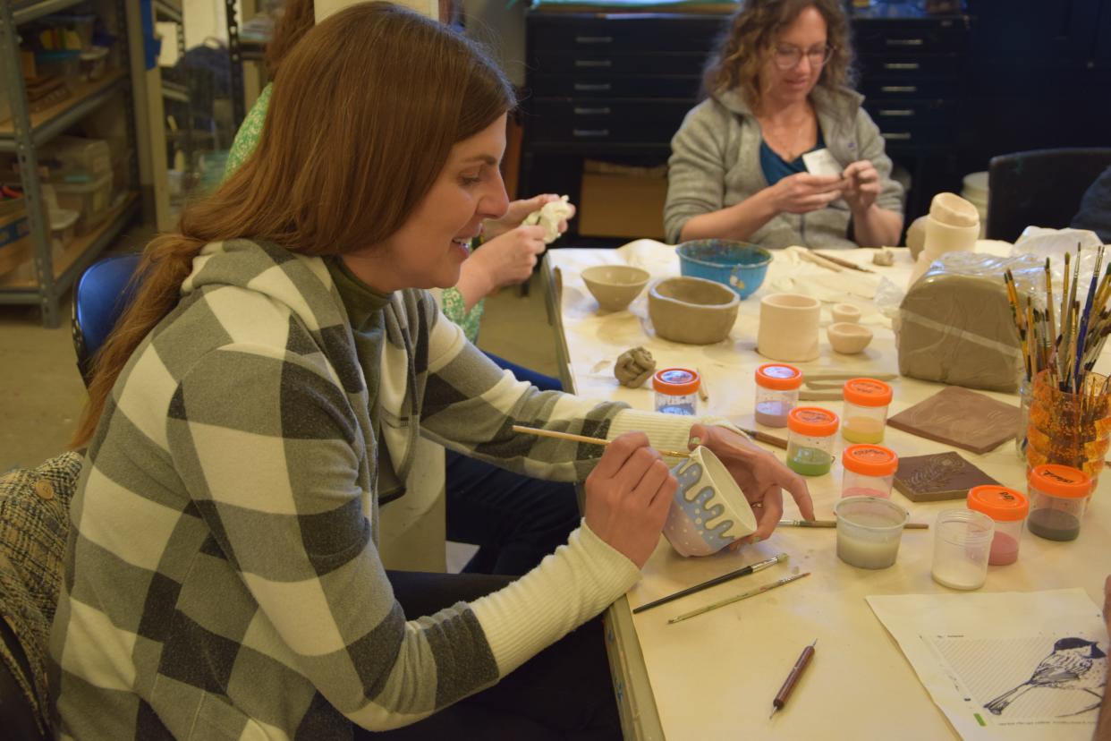 Elizabeth Mrozinski, a Harbor Light teacher, paints a bowl during the pottery workshop during Crooked Tree Arts Center's professional development day on April 15, 2024.