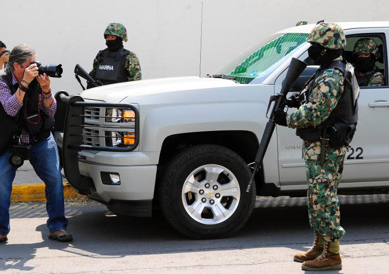 Members of the Mexican Navy stand guard during an operation to present Mexican drug trafficker Joaquin Guzman Loera aka "el Chapo Guzman" to the press, on February 22, 2014 in Mexico City