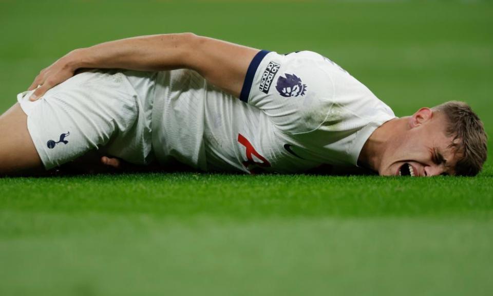 Micky Van de Ven of Spurs clutches his right hamstring as he lies injured during the Premier League match between Tottenham Hotspur and Chelsea.