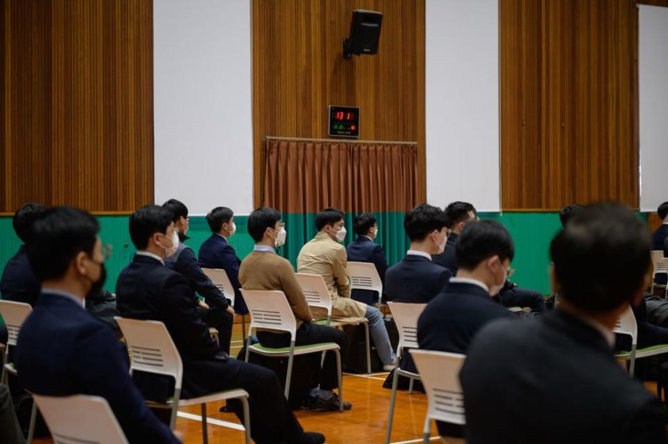 South Korean Jehovah's Witnesses, who are conscientious objectors to mandatory military service, await an induction session at a correctional facility where they will begin working, in Daejeon on October 26, 2020.<span class="copyright">ED JONES/AFP via Getty Images</span>