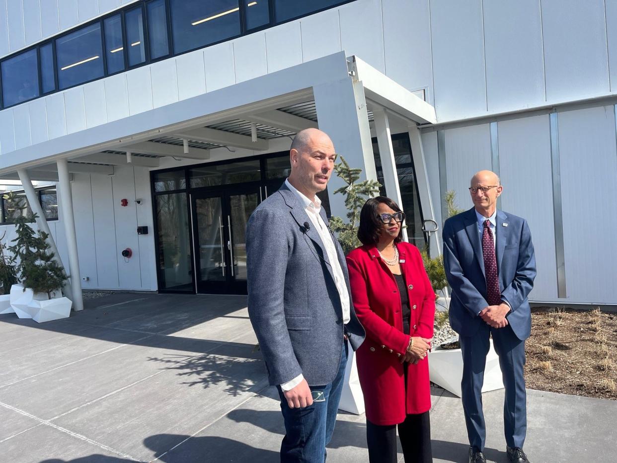 Kyle Clark, founder and chief executive officer of Beta Technologies, Reta Jo Lewis, president of the Export-Import Bank of the United States, and Owen Herrnstadt, board member of the bank (l to r), address reporters at Beta's manufacturing plant on April 2, 2024.