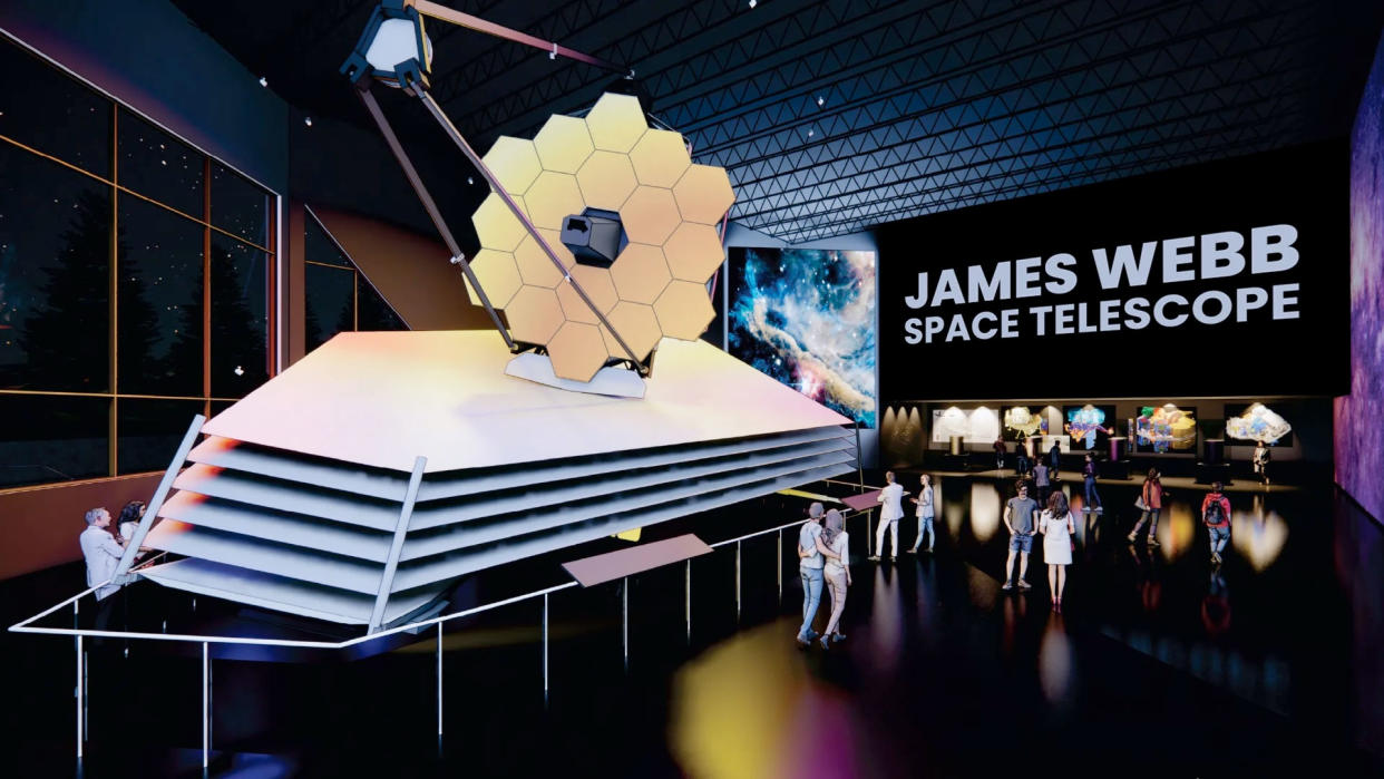  Artist's illustration showing a model of the James Webb Space Telescope on display in a museum, with people walking around it. 