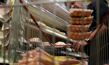 A member of the Public Health Surveillance Agency collects sausages to analyse in the laboratory, at a supermarket in Rio de Janeiro, Brazil, March 20, 2017. REUTERS/Ricardo Moraes