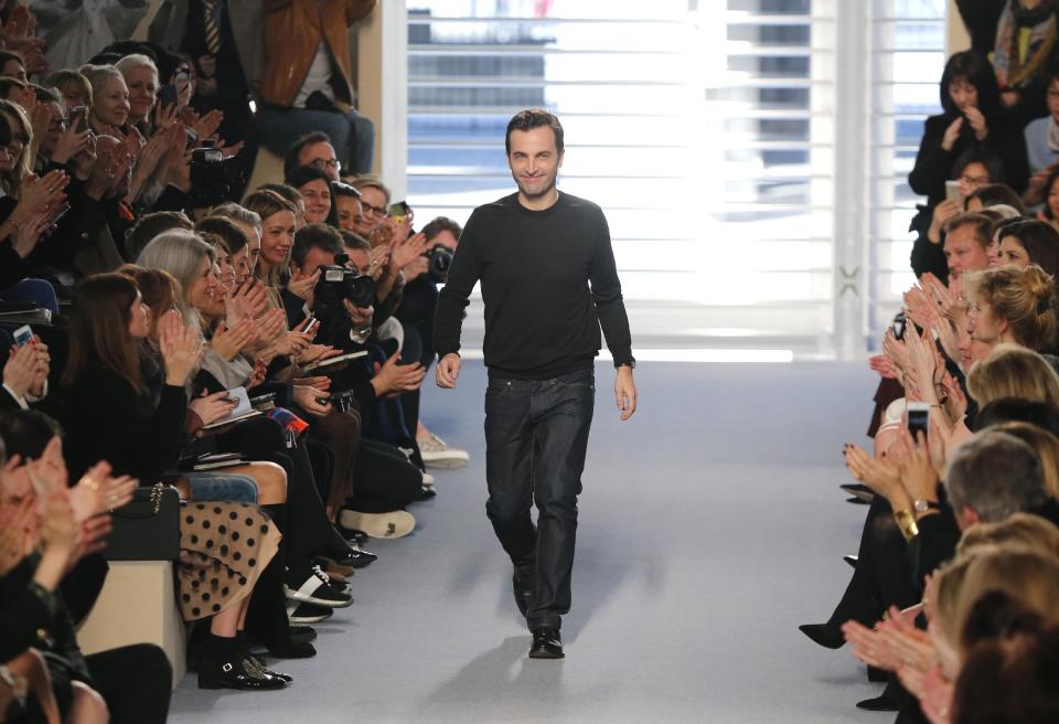 French creative director Nicolas Ghesquiere acknowledges applause after the presentation of Louis Vuitton's ready to wear fall/winter 2014-2015 fashion collection, in Paris, Wednesday, March 5, 2014. (AP Photo/Jacques Brinon)