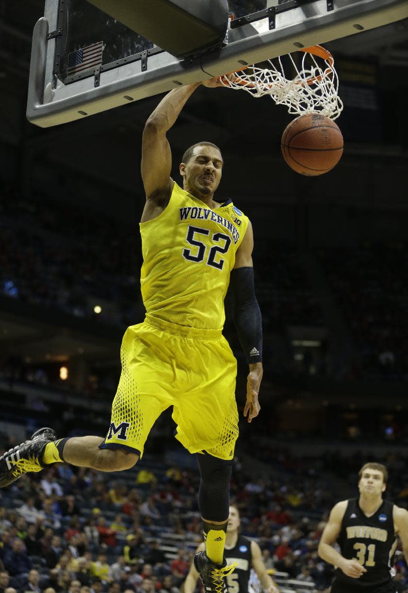 Michigan forward Jordan Morgan (52) dunks during the first half of a second round NCAA college basketball tournament game against the Wofford Thursday, March 20, 2014, in Milwaukee. (AP Photo/Morry Gash)