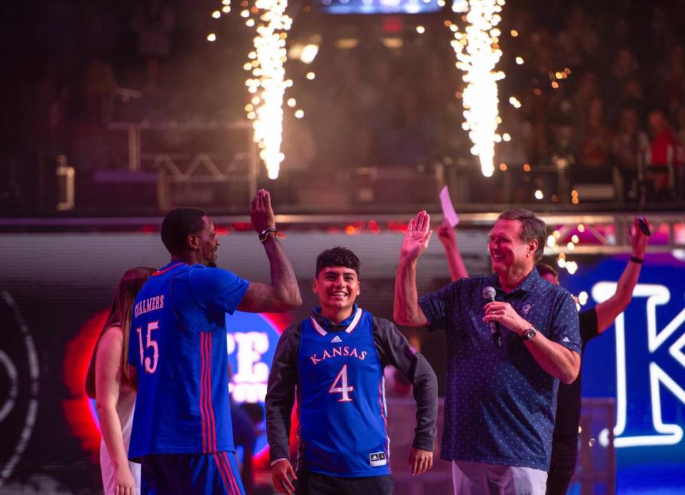Mario Chalmers, left, Jose Guzman, and Bill Self celebrate Chamlers half court shot Friday, Oct. 6, 2023, at Allen Fieldhouse in Lawrence. Guzman won $10,000 after Chalmers sunk the shot.