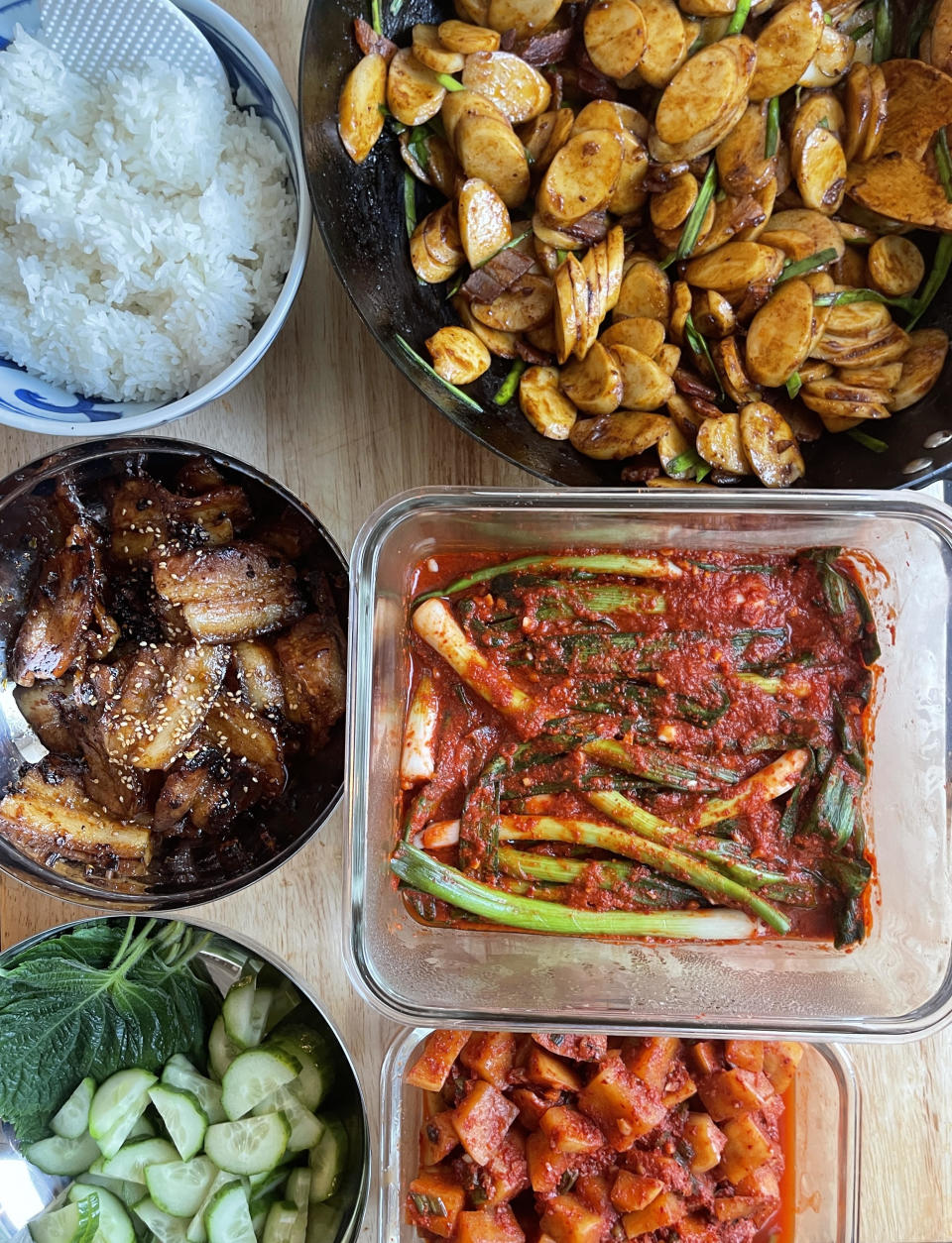 A photo of various Korean dishes and a bowl of rice.