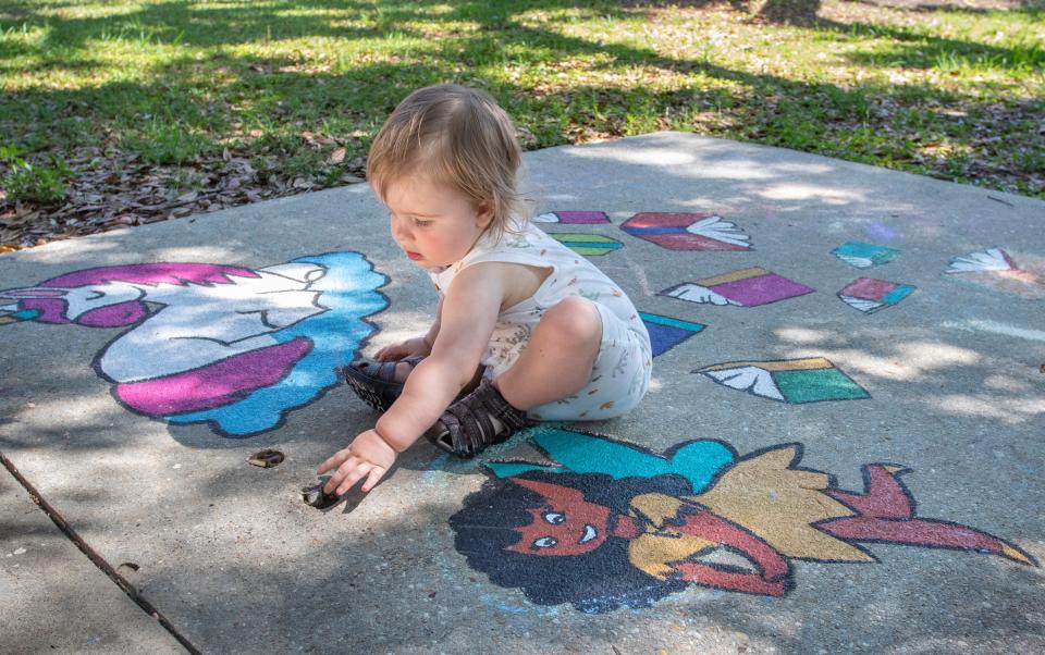 Ryder Greene, 1, checks out the artwork during the grand opening celebration for the Born Learning Trails at Highland Terrace Park in Pensacola on Tuesday.