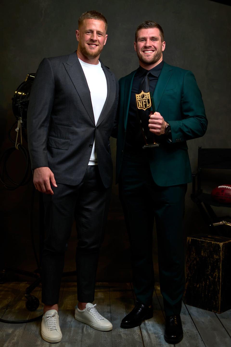 T.J. Watt poses with brother JJ for a portrait after winning the Deacon Jones Sack Leader Award during the NFL Honors