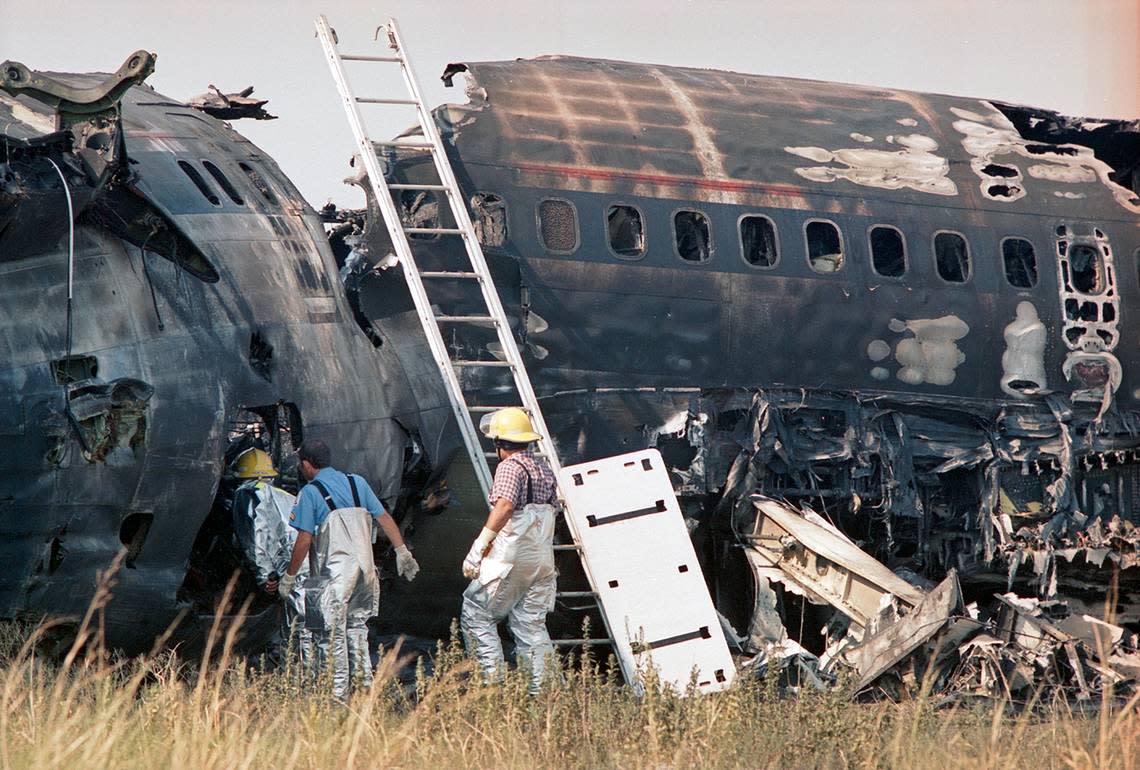 Aug. 31, 1988: Firefighters inspect the damage after extinguishing the flames that destroyed Delta 1141 after it crashed during takeoff from Dallas-Fort Worth International Airport.