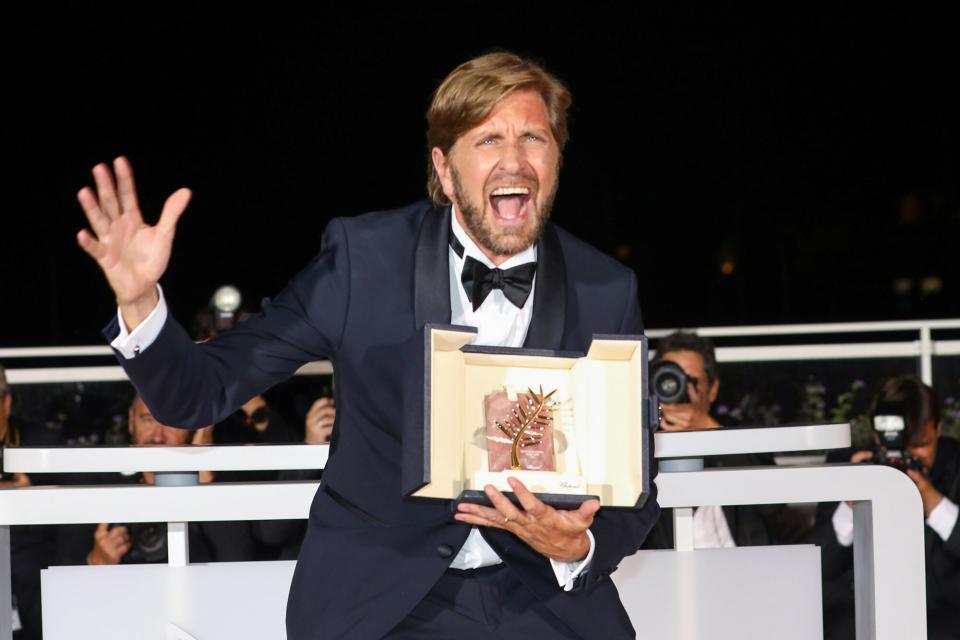 Ruben Ostlund poses with the Palme d'Or Award for "Triangle of Sadness" at the winner photocall during the winner photocall during the 75th annual Cannes film festival at Palais des Festivals on May 28, 2022 in Cannes, France.