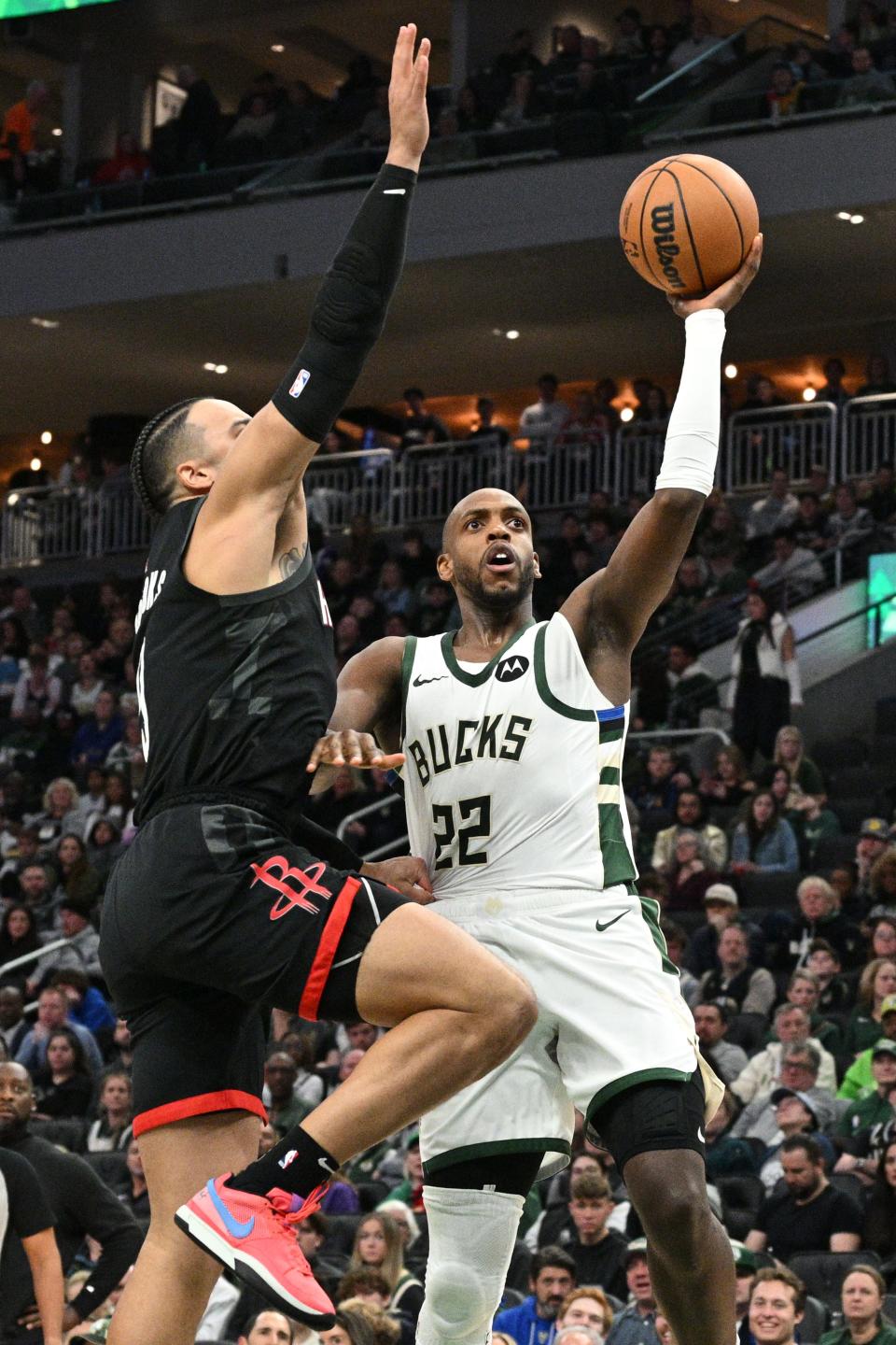 Bucks forward Khris Middleton drives to the basket against Houston Rockets forward Dillon Brooks on Dec. 17 at Fiserv Forum.