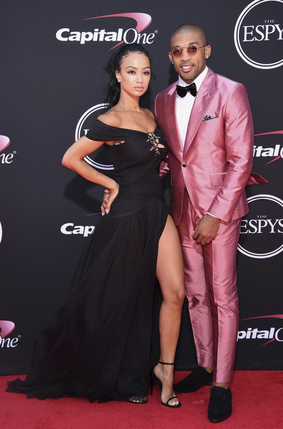 Draya Michele wearing a black gown with a high slit and NFL football player Orlando Scandrick of the Dallas Cowboys