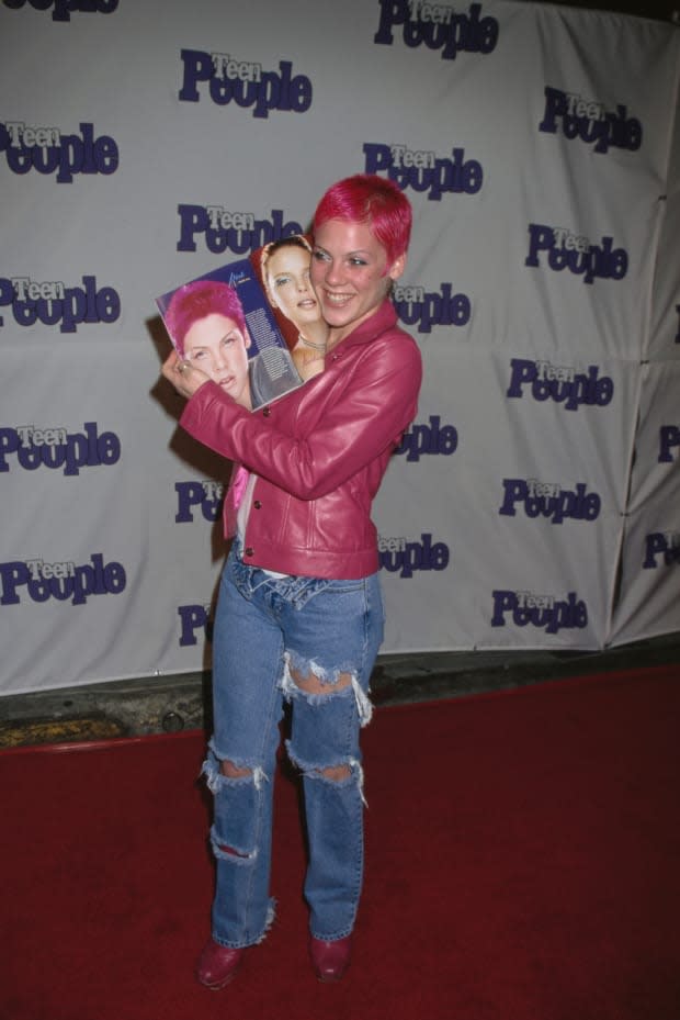 Pink rocks pink hair, a pink leather jacket and torn jeans at Teen People's 2nd Annual "What's Next" Issue Launch Party, held at Vynyl in Los Angeles on Jan. 14, 2000.<p><a href="https://www.gettyimages.com/detail/1353993412" rel="nofollow noopener" target="_blank" data-ylk="slk:Michael Ochs Archives/Getty Images;elm:context_link;itc:0;sec:content-canvas" class="link ">Michael Ochs Archives/Getty Images</a></p>