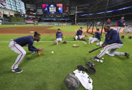 From left to right, Atlanta Braves second baseman Ozzie Albies, Dansby Swanson, Austin Riley and Freddie Freeman work with third base coach Ron Washington at Minute Maid Park during team practice the day before playing the Houston Astros in Game 1 of the World Series, Monday, Oct. 25, 2021, in Houston. (Curtis Compton/Atlanta Journal-Constitution via AP)