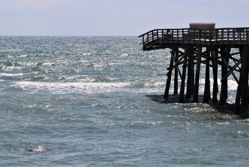 Part of what appears to be a piling is visible floating in the surf (lower left) on Monday, June 17, 2024, after breaking away recently from the Flagler Beach Pier, which has been closed since Tropical Storm Ian tore away a chunk in September 2022.