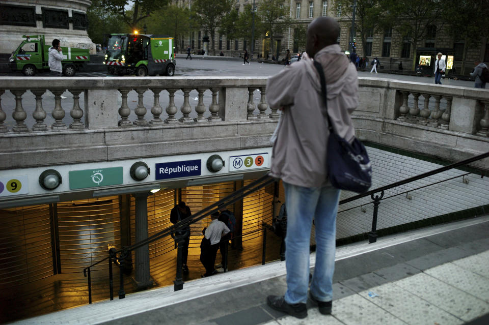 A man stands in front of the closed gate of the Republique square metro station, in Paris, Friday, Sept. 13, 2019. Paris metro warns over major strike, transport chaos Friday. (AP Photo/Thibault Camus)